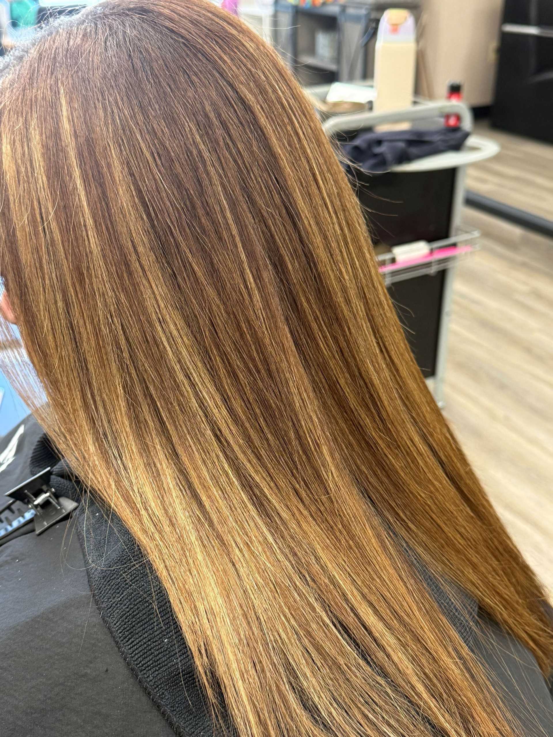 Stylish hair with caramel highlights at a salon.